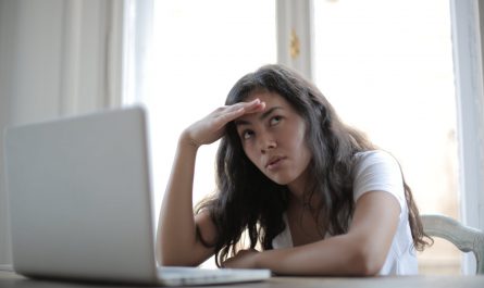 young annoyed female freelancer using laptop at home